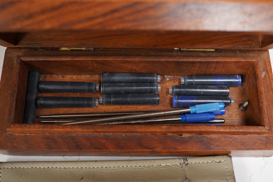 A group of five fountain pens and ballpoint pens